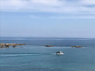 a boat in the middle of a large body of water at Frini Hotel in Chania Town