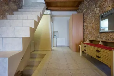 a room with a staircase and a stone wall at Dimitra's House in Old Town in Chania Town