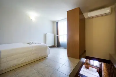 a bedroom with a bed and a large window at Dimitra's House in Old Town in Chania Town