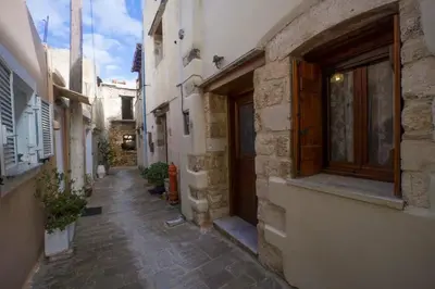 an alley in an old stone building with a window at Dimitra's House in Old Town in Chania Town