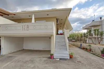 a house with a staircase leading to a garage at Gianna's House in Gerani Chanion