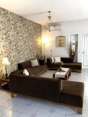 a living room with two couches and a wall at Rosy's House with all Amenities near Chania in Chania Town