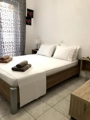 a bedroom with a large bed with towels on it at Rosy's House with all Amenities near Chania in Chania Town