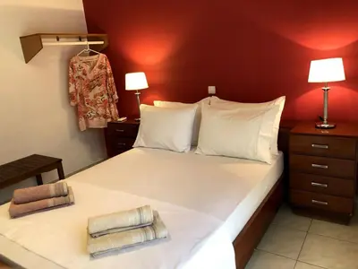 a bedroom with a bed with two towels on it at Rosy's House with all Amenities near Chania in Chania Town