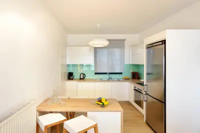 a kitchen with a wooden table and a refrigerator at Elia Beach in Chania Town