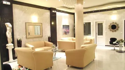 a waiting room with couches and chairs in a building at Elektra Beach Hotel in Kalamaki Chanion
