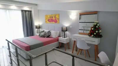 a bedroom with a bed and a christmas tree in it at Elektra Beach Hotel in Kalamaki Chanion