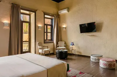a bedroom with a bed and a tv on the wall at Alcanea Boutique Hotel in Chania Town