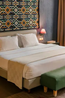 a bedroom with a large bed and a wall at Alcanea Boutique Hotel in Chania Town