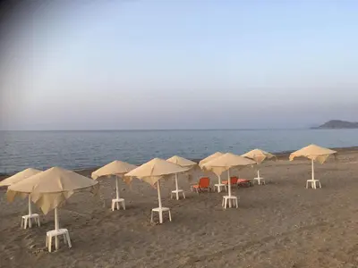 a group of chairs and umbrellas on a beach at Stellar Beachhouse in Gerani Chanion