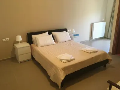 a bedroom with a large bed with two towels on it at Stellar Beachhouse in Gerani Chanion