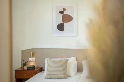 a bedroom with a bed and a picture on the wall at Artemis Apartments in Stalos