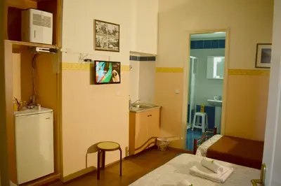 a small room with a kitchen and a bathroom at Stoa Rooms in Chania Town