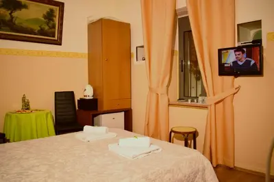 a room with a bed with two towels on it at Stoa Rooms in Chania Town