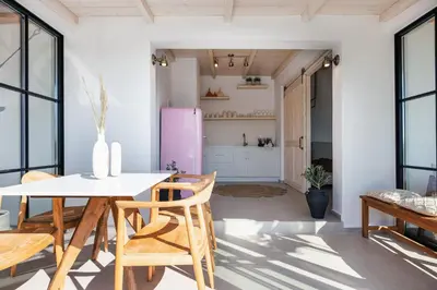 a kitchen and dining room with a white table and chairs at San Pietro Villa in Plataniás