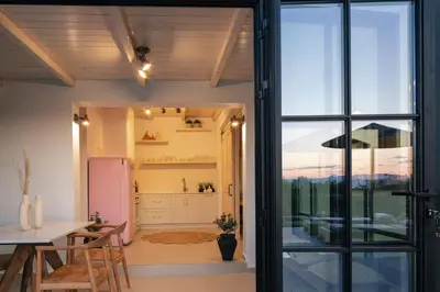 a kitchen with a table and a refrigerator at San Pietro Villa in Plataniás