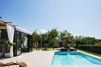 a swimming pool in the backyard of a house at San Pietro Villa in Plataniás