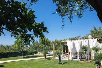 a garden with a pool and a pavilion at San Pietro Villa in Plataniás