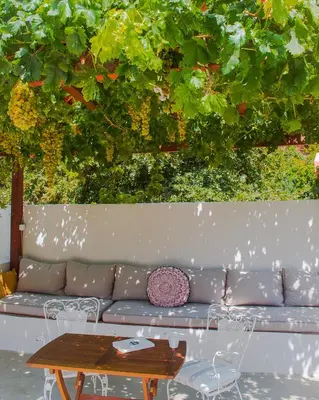 a couch with a coffee table and a table with at Feneri Traditional House Apt 1- 20' from Elafonisi beach in Elafonisi