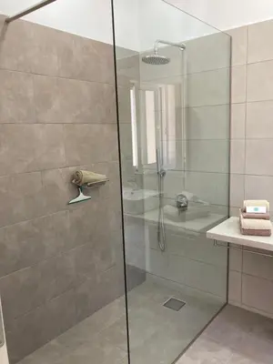 a shower with a glass door in a bathroom at WeCrete Apartments in Drapaniás