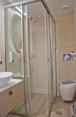 a shower with a glass door in a bathroom at Hotel Christina in Chania Town