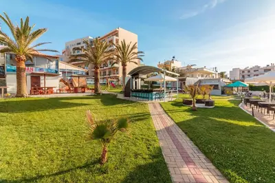 a park with palm trees and buildings at Hotel Christina in Chania Town