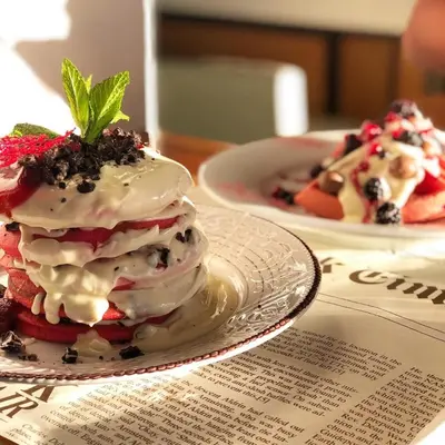 a stack of desserts on a plate on a table at Stelisia Rooms in Chania Town