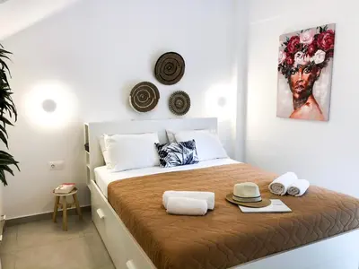 a bedroom with a bed with hats and towels on it at Stelisia Rooms in Chania Town