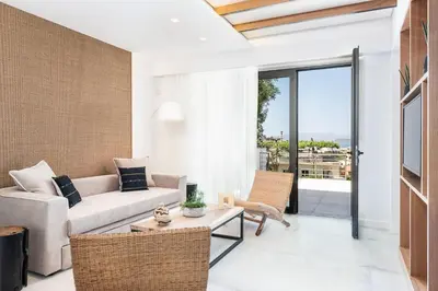 a living room with a couch and a table at Blue Island Luxury Apartment in Kato Daratso