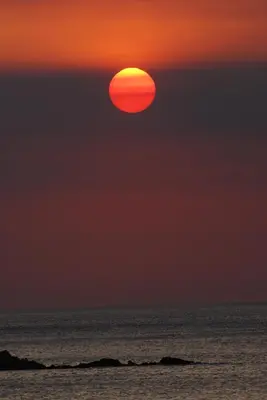 a sunset over the ocean with the sun in the sky at Kavousi Resort in Falasarna