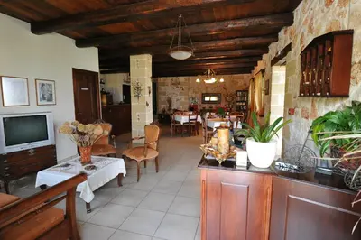 a living room with a television and a dining room at Kavousi Resort in Falasarna
