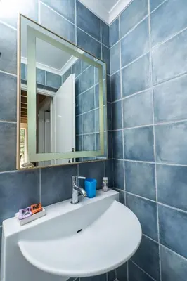 a bathroom with a white sink and a mirror at Rodanthi Villas in Darmarochori