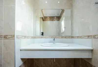 a bathroom with a sink and a mirror at Vasso Apartments in Kissamos