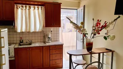 a kitchen with a table with a vase of flowers on it at Irene's studio in chania in Chania Town