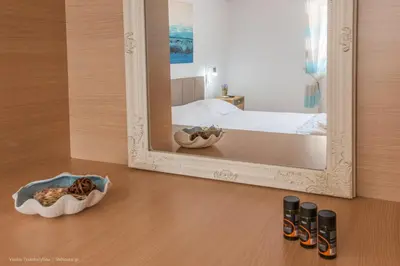 a mirror sitting on the floor next to a bed at Orama in Kato Daratso