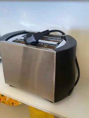 a black toaster sitting on a shelf at Maria & Zachos House in Kissamos