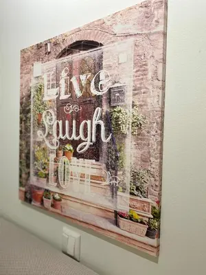 a painting of a sign on a wall with plants at Maria & Zachos House in Kissamos