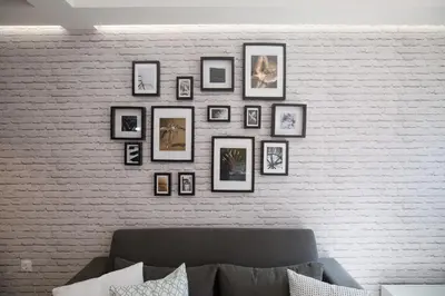 a wall with a bunch of framed pictures on it at Chalepa Boutique Apartment in Chania Town