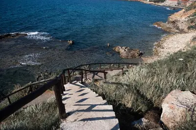 a stairway leading down to a beach with the water at Chalepa Boutique Apartment in Chania Town
