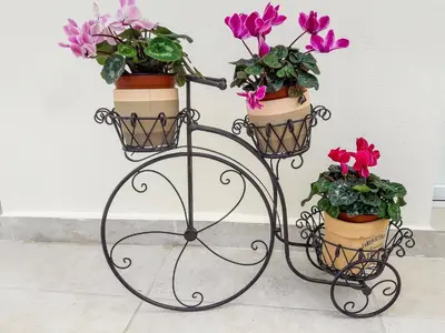 a metal plant stand with two flower pots on it at Grande Casa 1926 in Chania Town