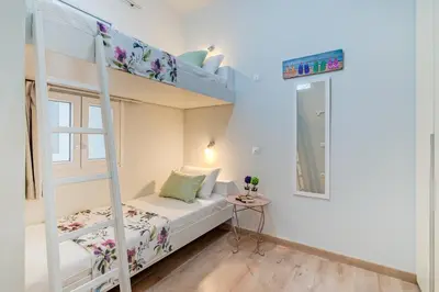 a small bedroom with a bunk bed and a ladder at Casa 1926 in Chania Town