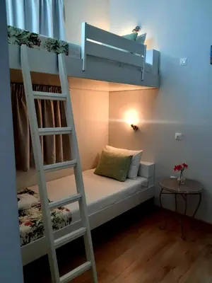 a bunk bed with a ladder in a room at Casa 1926 in Chania Town