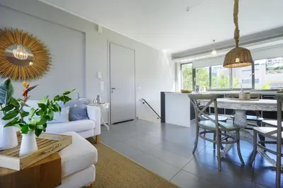 a living room with a table and a couch at 3 bdr apartment 5 km from the city in Agios Onoufrios