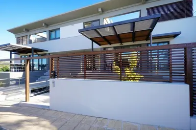 a house with a fence and a white wall at 3 bdr apartment 5 km from the city in Agios Onoufrios