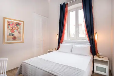a bedroom with a white bed and a window at Camara Residence in Chania Town