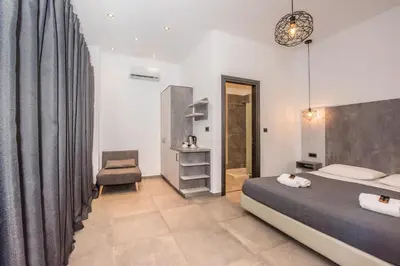 a bedroom with a bed and a chair at Xasteria in Elafonisi