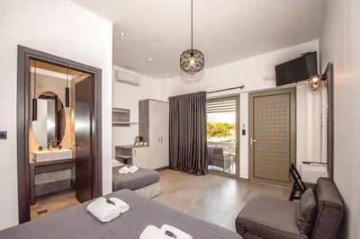 a hotel room with a bed and a bathroom at Xasteria in Elafonisi