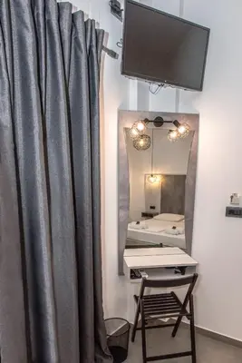 a room with a curtain and a mirror at Xasteria in Elafonisi