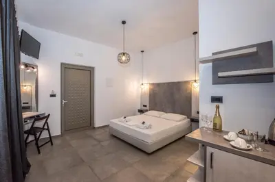 a large white bathroom with a tub and a table at Xasteria in Elafonisi