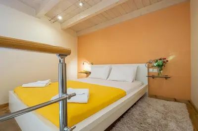 a bedroom with a bed with a yellow blanket at Boutique Hotel Fortino in Chania Town